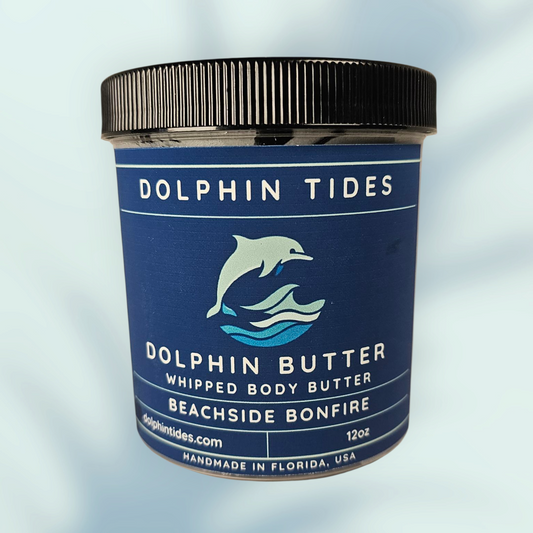 Dolphin Tides whipped body butter jar on a light blue background