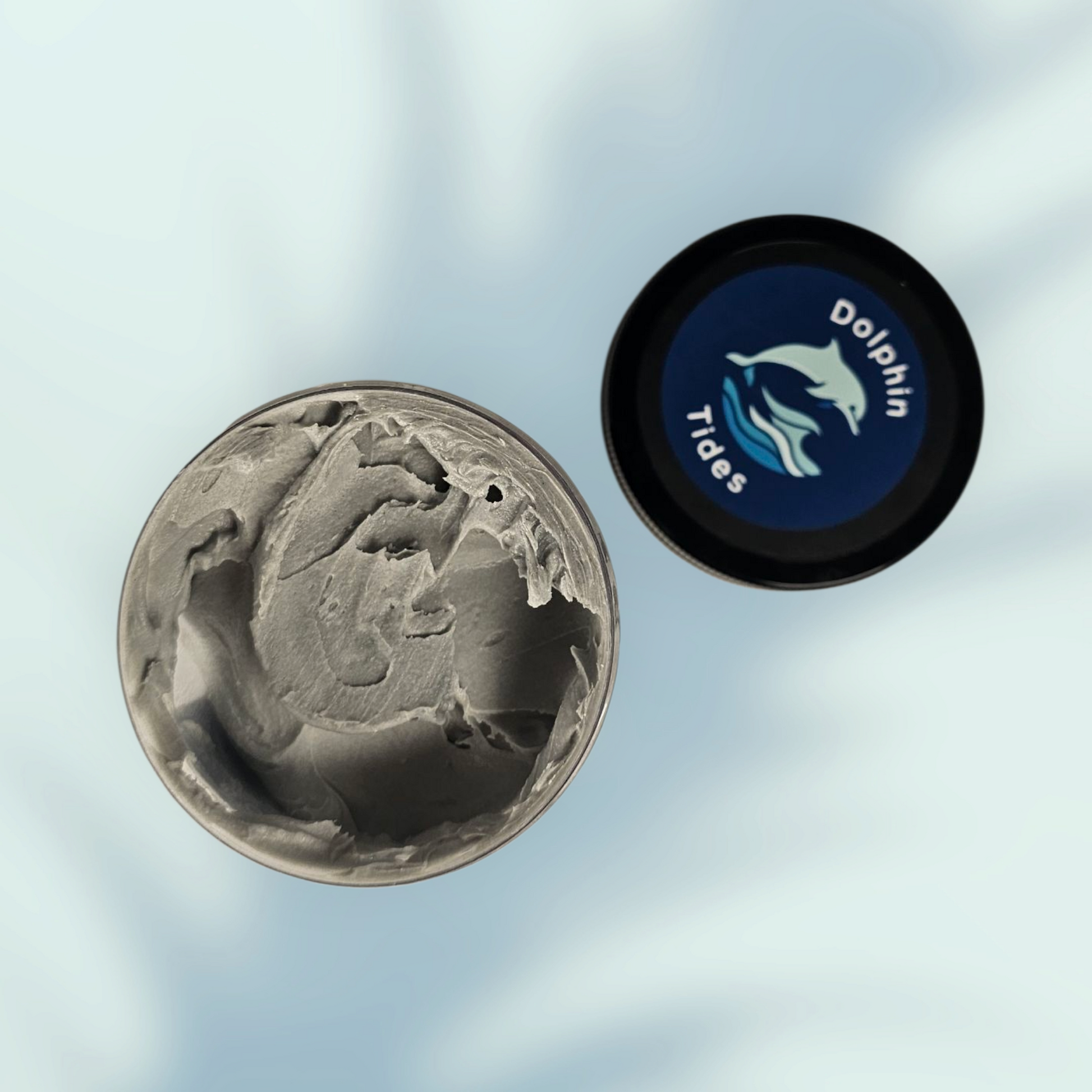 Two circular objects, one with a textured surface and the other with a logo, on a light blue background.