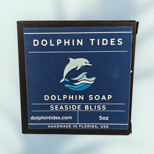 Dolphin Tides soap packaging with branding and product details on a light blue background