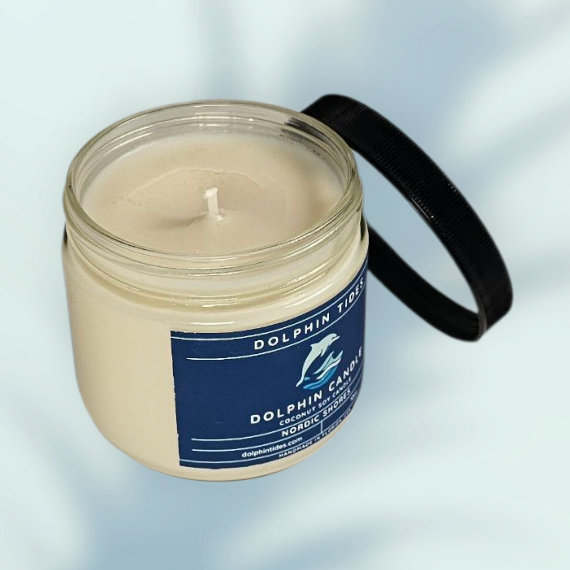 Candle in a jar with a blue label on a light gray background