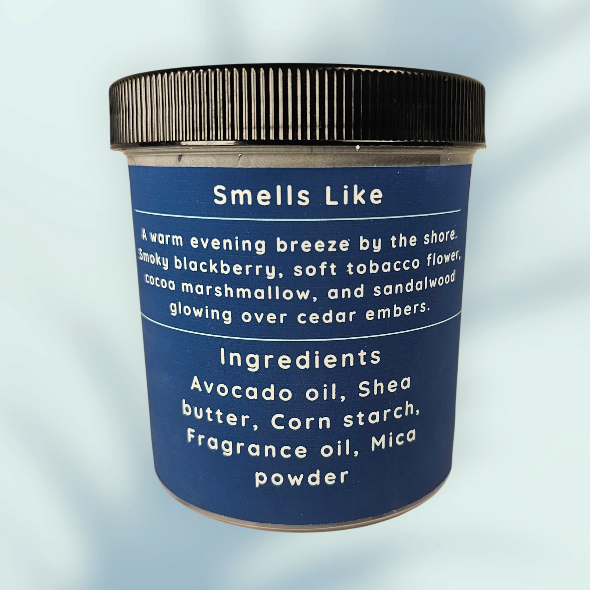 Jar with blue label detailing scent and ingredients on a light blue background