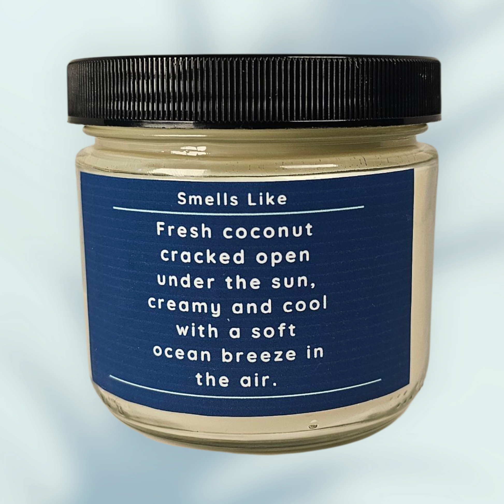 Jar with a blue label describing a coconut fragrance on a light blue background